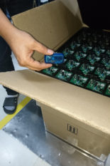 Ready for transport monitoring: Having started the recording of an MSR145 data logger by pushing the button, it is packaged in a cardboard box together with the printed circuit board assemblies. Source: Belimo Automation AG