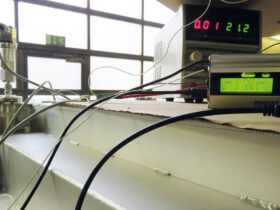 Der MSR255 Datenlogger mit Drucksensor und Temperatursensor im Einsatz an der bis auf 3,1 mbar absolut luftleer gepumpten Vakuumkammer (ganz links): Dort überwacht er Druck und Temperatur. Das Labornetzgerät im Hintergrund speist den am Kleinflansch der Vakuumkammer angebrachten Drucksensor für einen Druck von 0-1 bar absolut. Der Temperatursensor (weisses Kabel) ist an der Kammerwand befestigt. Bildquelle: Climeworks AG